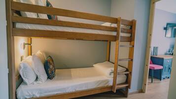 A bunk bed with a ladder, white bedding, and decorative pillows.