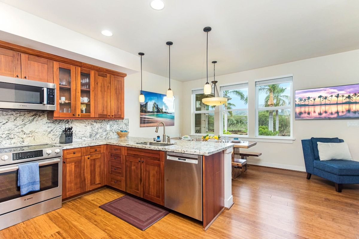 A modern kitchen with wooden cabinets, a stainless steel dishwasher, and a large island.