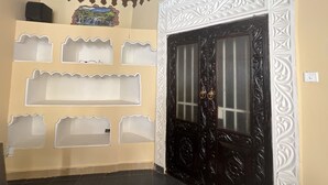 A room with a decorative door, a shelf unit, and a ceiling with wooden beams. - Beautiful 3 Bedroom Villa in Diani Beach-sleeps 8 (Diani)