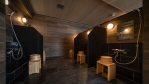 A modern bathroom with dark tiles, wooden accents, and built-in lighting. - HOTEL SHURANZA MAKUHARI BAY (Chiba)