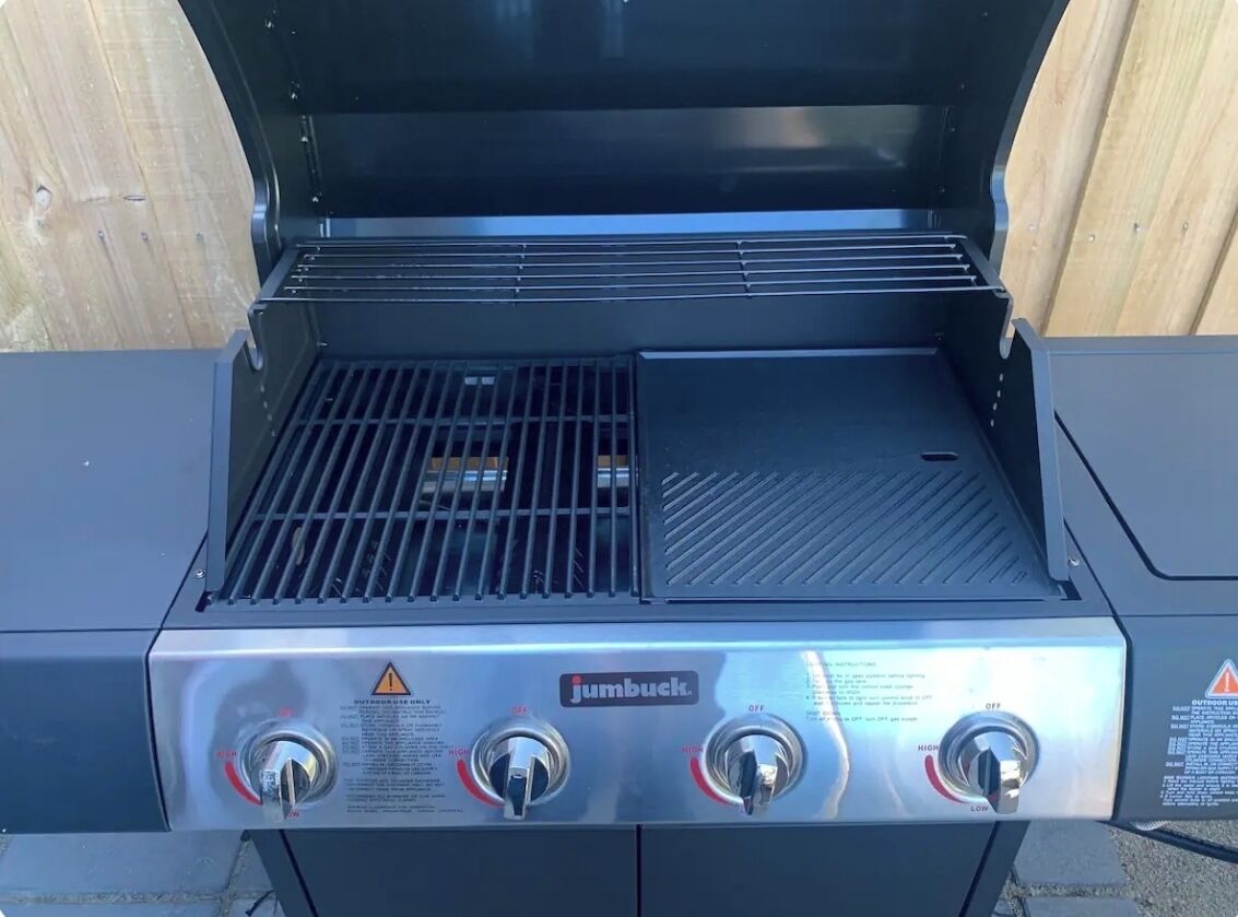 A Jumbuck portable grill with three control knobs and a vented lid.
