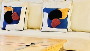 En sofa med to puder med abstrakte mønstre.