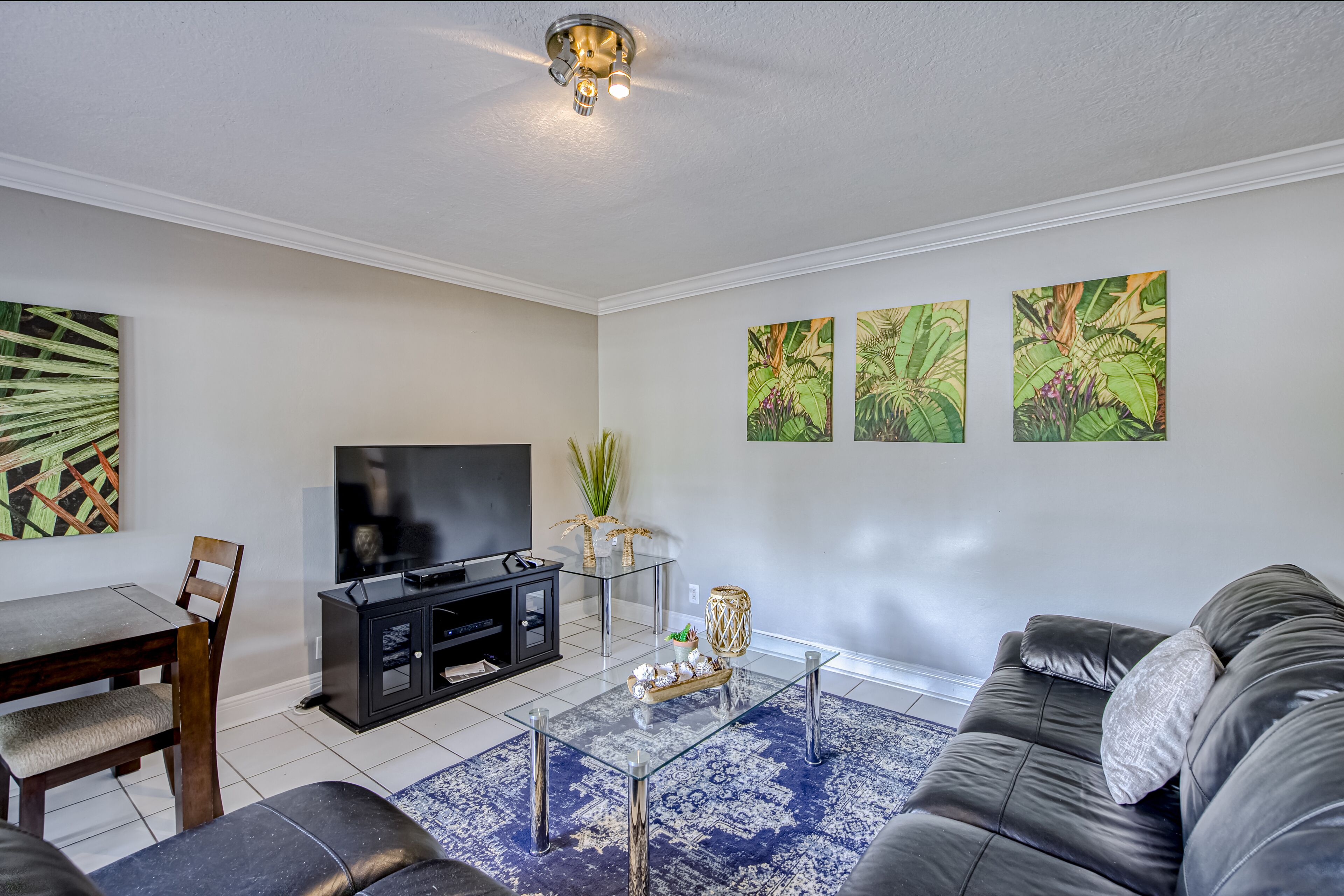 Ground-floor condo near beach with shared patio, grill, central AC, & WiFi