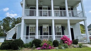 A two-story house with a porch, columns, and a symmetrical facade. - Luxury stay  at 4 bedroom house (Florence)