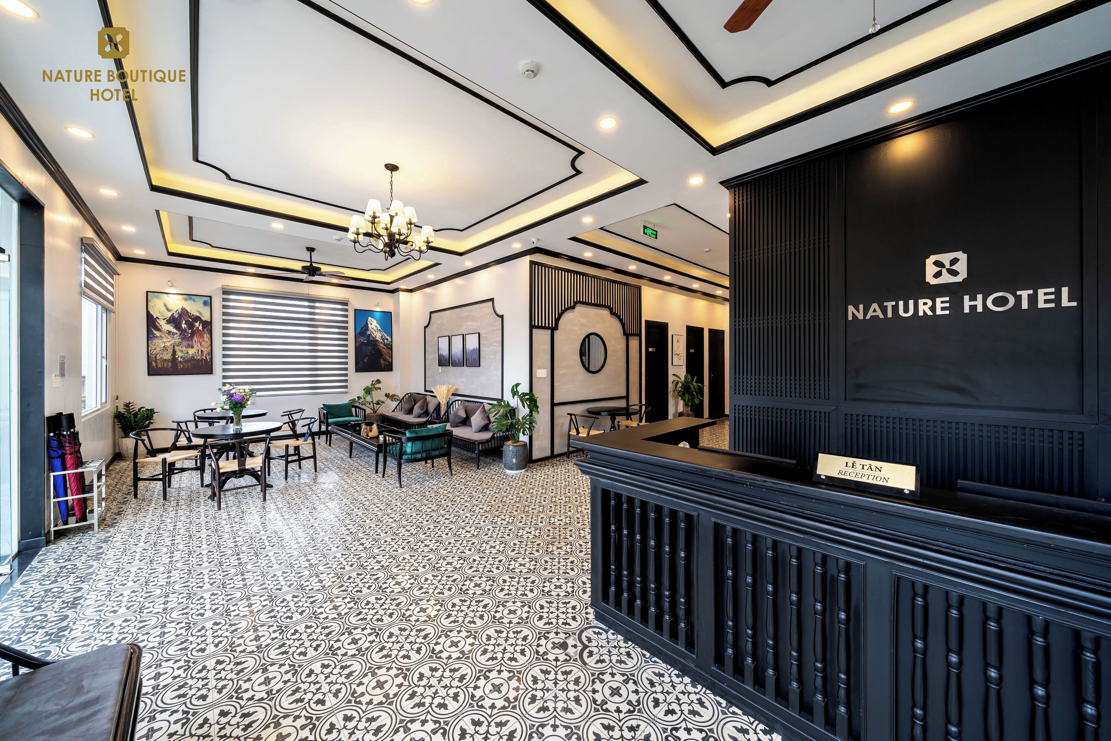 A hotel lobby with a reception desk, seating area, and decorative elements.