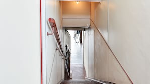 A staircase with a metal railing and a bicycle leaning against the wall. - Hotel O Pulau Ketam Inn (Pulau Ketam)