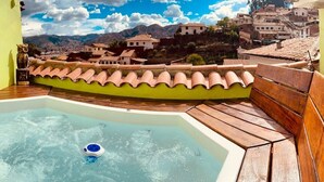 A hot tub with a view of a hillside town. - Historic Cusco ∞ Experience Luxury ∞ El Nuevo Sol ∞ Staffed Villa (Cusco)