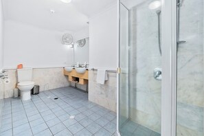 A modern bathroom with a toilet, sink, and shower. - 1 Bedroom Apartment 301/1 in Alassio Resort (Palm Cove)