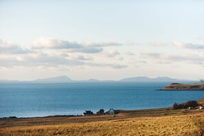 A coastal landscape with a clear view of the sea and distant mountains. - An Cala Beag Self Catering apartment on The Waternish Peninsula   (Waternish Isle Of Skye)