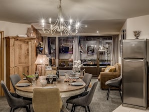 Enjoy meals in the spacious kitchen and dining area, featuring a round table and comfortable seating.