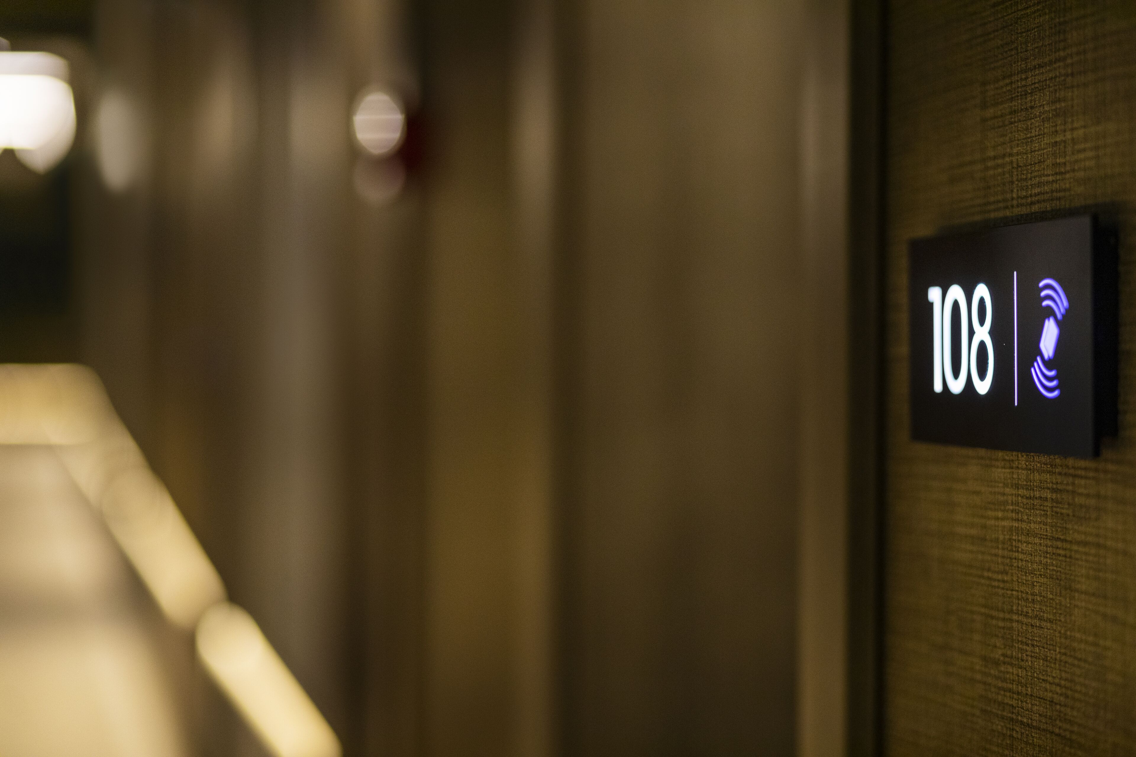 A hallway with a sign indicating room number 108.