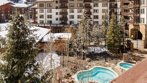 A resort with multiple buildings, a swimming pool, and snow-covered trees. - RARE Three Bedroom Lovely Passage Point Condo!! (Copper Mountain)