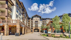 A multi-story hotel with a stone facade, balconies, and a central entrance. - RARE Three Bedroom Lovely Passage Point Condo!! (Copper Mountain)