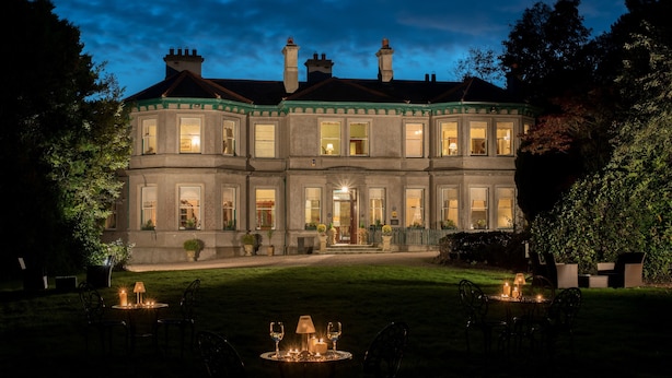 A large, historic building with multiple windows and a well-lit entrance. - Ardtara Country House (Maghera)