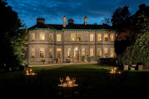 A large, historic building with multiple windows and a well-lit entrance. - Ardtara Country House (Maghera)
