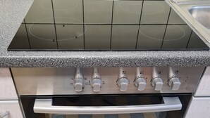 Une cuisine équipée d’un four encastré et d’une plaque de cuisson.