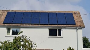 A building with a flat roof and solar panels installed on the top. - Smart 3 bed Apartment With Fast Wi-fi & 24hr Light (Abuja)