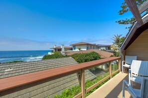 A balcony with a view of the ocean, wooden deck, and white chairs. - Oceanview, Walk To Beach, Fire Pit, BBQ, Backyard (Carlsbad)