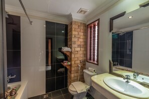 A bathroom with a bathtub, toilet, and sink.