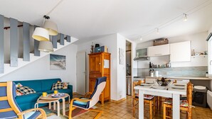 A modern apartment with a living area, dining space, and kitchen.