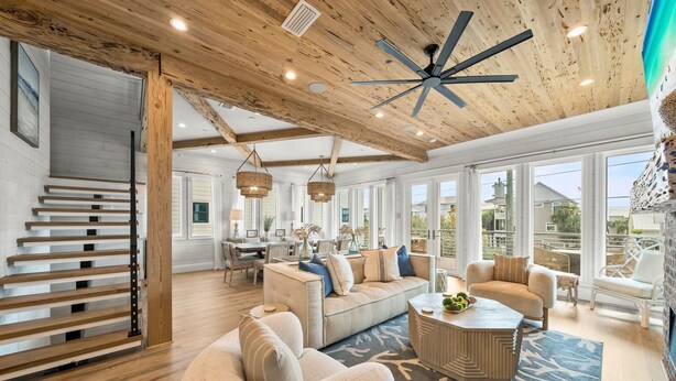 A spacious living area with a high ceiling, wooden beams, and large windows. - Summer Wind 7 Bedroom Home by RedAwning (Santa Rosa Beach)