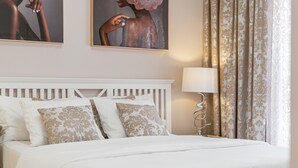 A neatly made bed with white and patterned pillows, a white headboard, and a bedside lamp. - Vacation Villa 'Ocean View 3bedroom  with Pool' with Sea View, Wi-Fi and Air Conditioning (Callao Salvaje)