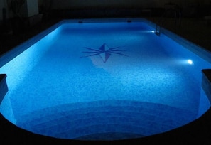 A swimming pool with a star-shaped design on the floor.