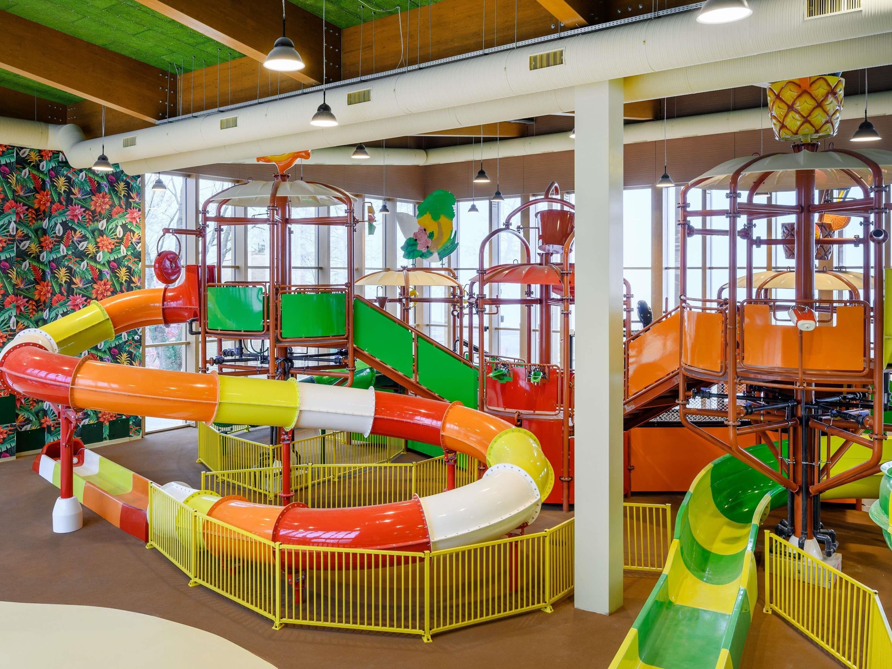 A play area with colorful slides and play structures.