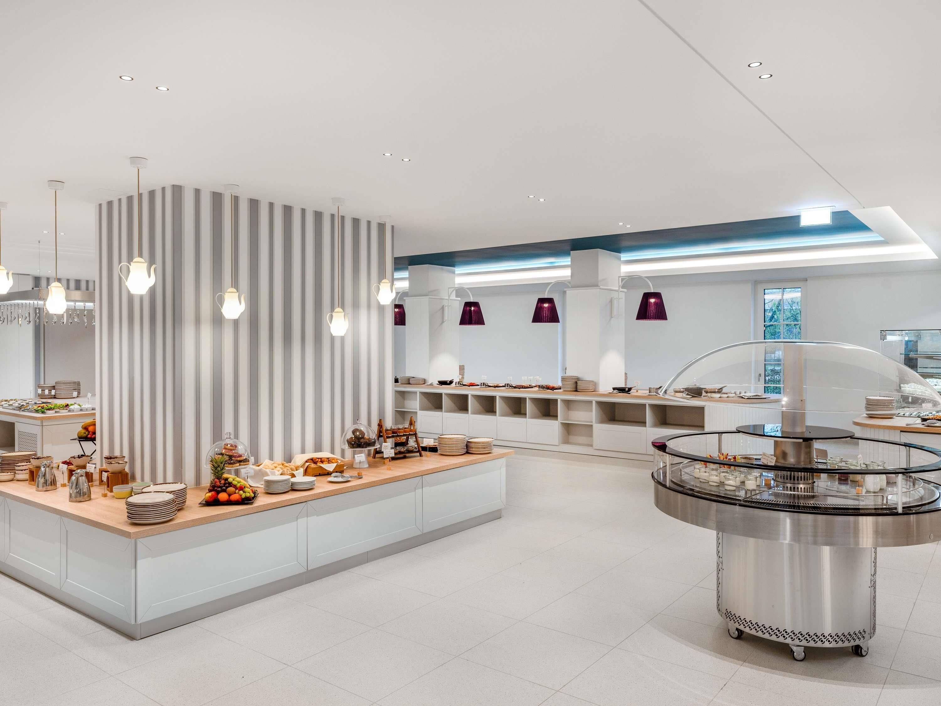 A modern breakfast bar with a variety of food items and a coffee station.