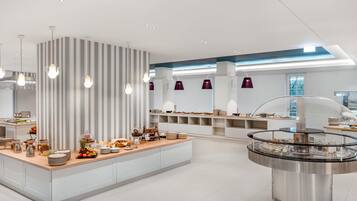 A modern breakfast bar with a variety of food items and a coffee station.