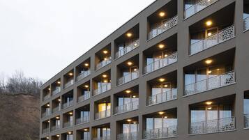 A modern hotel with multiple balconies, a visible entrance, and a sign reading "MINARO HOTEL".