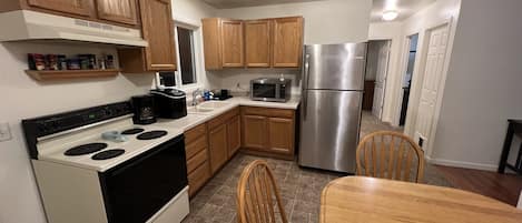 Full-sized fridge, microwave, cookware/dishes/utensils