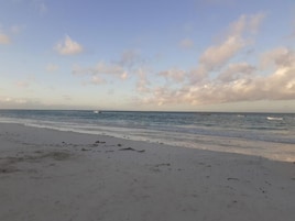 On the beach, white sand, beach towels, beach massages