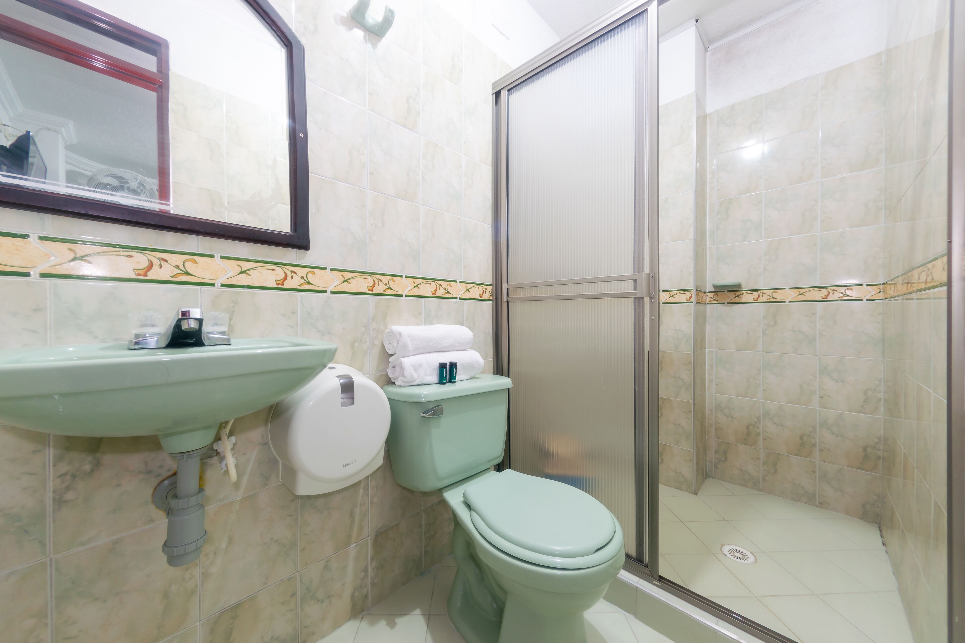 A bathroom with a sink, toilet, and shower.