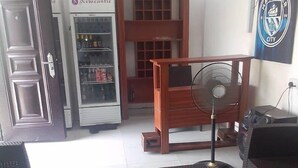 A room with a refrigerator, a fan, and a couch. - Homewood Suites (Lekki)