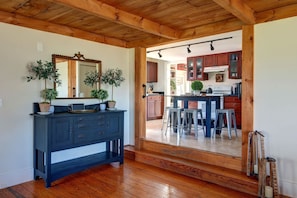 A wooden ceiling, a dark blue dresser, and a kitchen with wooden cabinets and stools. - Pet friendly Skaneateles country home one mile from downtown!! (Skaneateles)