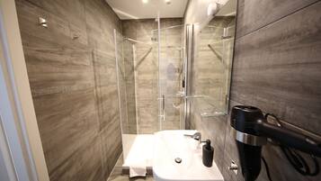 Deluxe Studio | Bathroom | Shower, hair dryer, towels, soap