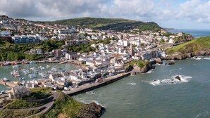 A coastal town with a marina, residential buildings, and a prominent church.