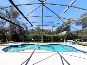A covered swimming pool with a hot tub, surrounded by a metal frame and a hedge. - MEGA VALUE! Serenity By The Pool! Close 2 Disney! 1445 (Clermont)