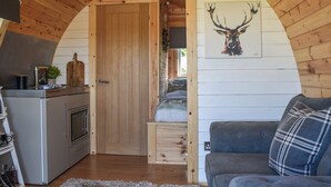 A cozy cabin interior with a kitchen, a dining area, and a living room. - Joshua's Den - UK40975 (Near Swansea)
