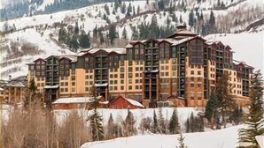A multi-story hotel with a symmetrical facade, large windows, and a central entrance. - The Grand Summit Hotel in the Canyons Village - Close to Golf - Pool, Gym, Spa, More! (Park City)