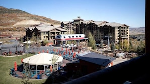 A large resort with multiple buildings, outdoor seating areas, and a ski lift visible.