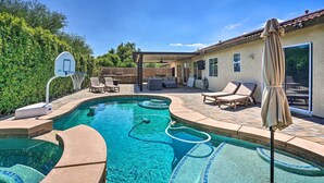A backyard with a swimming pool, a basketball hoop, and outdoor seating. - Pool & Game Room: Pet-Friendly Indio Retreat (Indio)