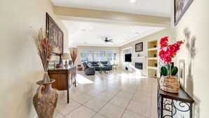 A spacious living room with a sofa, coffee table, and decorative items.