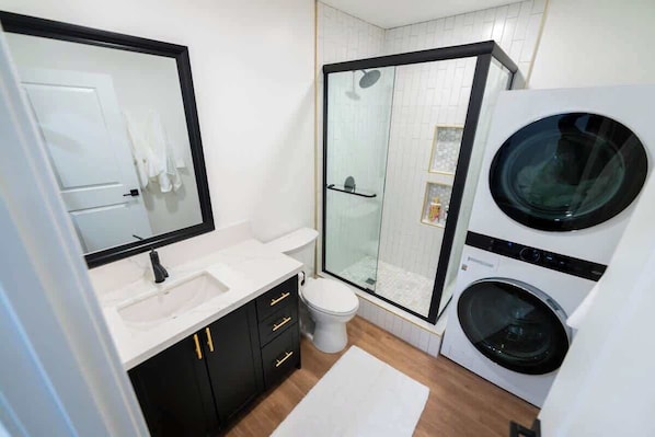 Shower, hair dryer, towels, shampoo