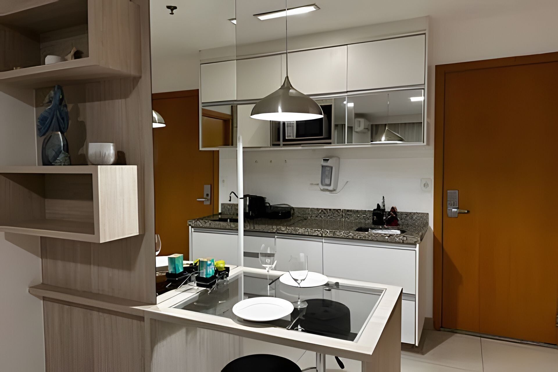 A compact kitchen with a central island, a microwave, and a sink.