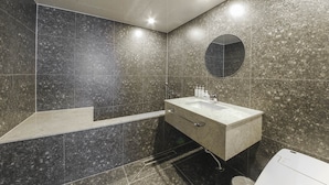 A modern bathroom with a marble vanity, a large mirror, and a shower area. - BONATREE HOTEL (Busan)