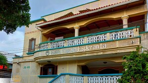 A hotel named "Hotel Nueva Esperanza" with a traditional architectural style, featuring balconies and decorative railings. - Hotel Nueva Esperanza (Barranquilla)