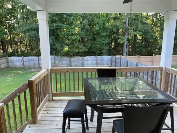 Relax in a serene outdoor space with a deck, table, and chairs.
