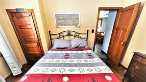 A bedroom with a bed, a wall-mounted sign, and a door. - Lakeview Retreat, Lakeside on the Flowage (Butternut)